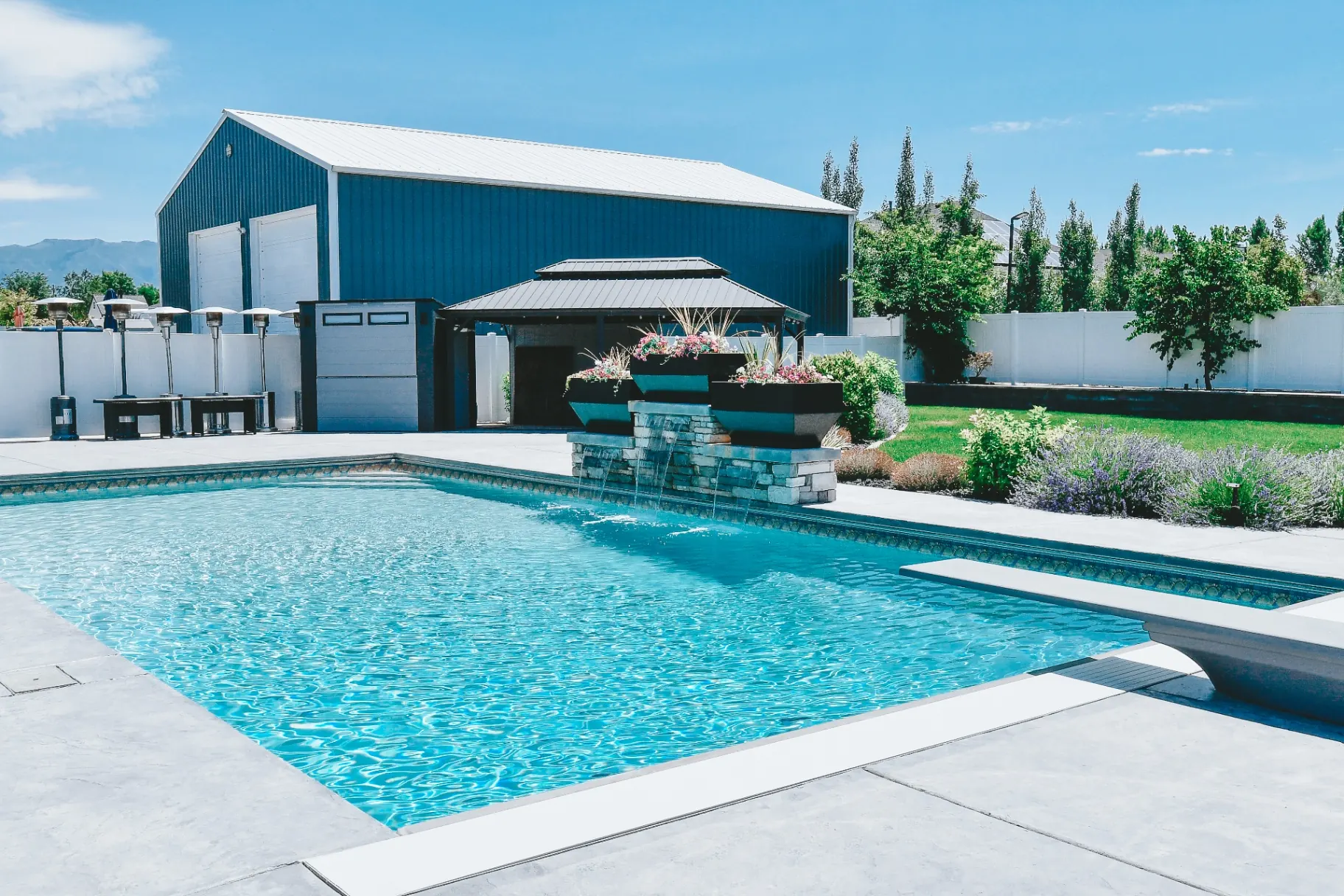 West Haven Utah Pool with Covered Pavilion - Barr Pool Builders Backyard vinyl swimming pool with covered pavilion, outdoor heaters and shop in West Haven, Utah custom built by Barr Pool Builders